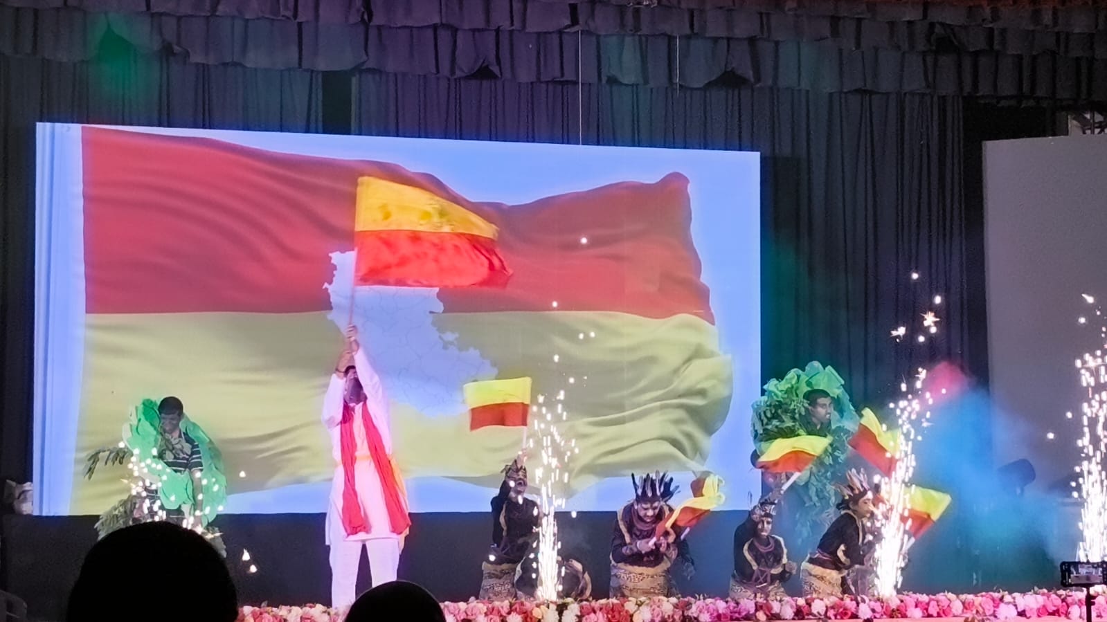 A patriotic dance performance celebrating the Kannada flag and Karnataka's heritage
