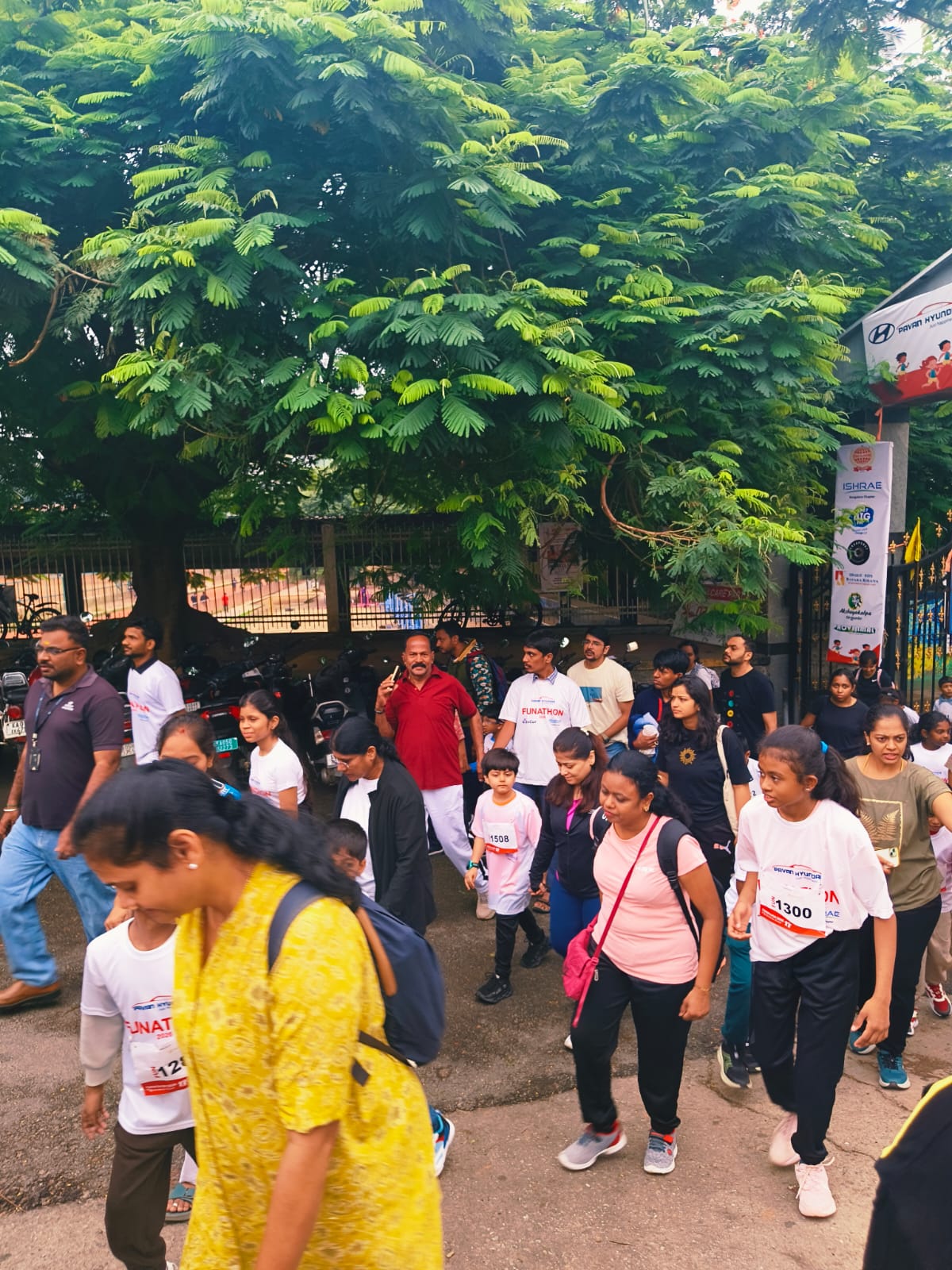 Families and children wearing numbered bibs walking together during the Funathon 2026 walkathon