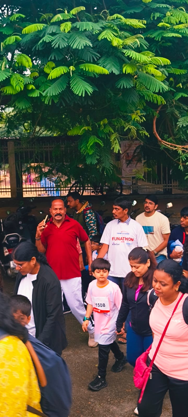 A child participant wearing bib number 1508 walking with family during the Funathon 2026 walkathon